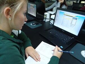 A student records data tracking sturgeon movements.