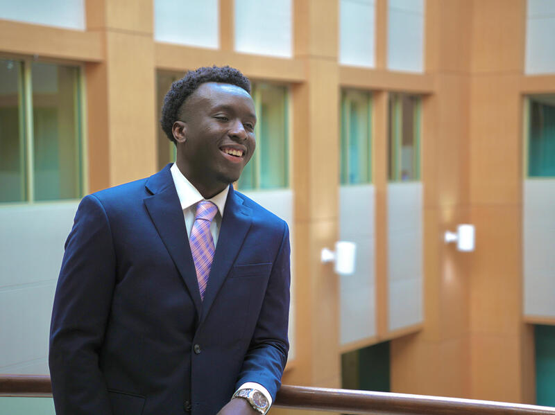 A photo of a man from the waist up. He is wearing a suit and tie. 