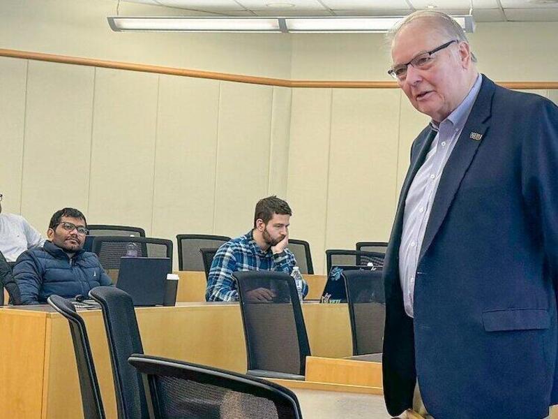 Stephen Custer, standing in a classroom and greeting VCU’s spring 2024 Master of Decision Analytics Weekend Program students as the semester began. (VCU School of Business)