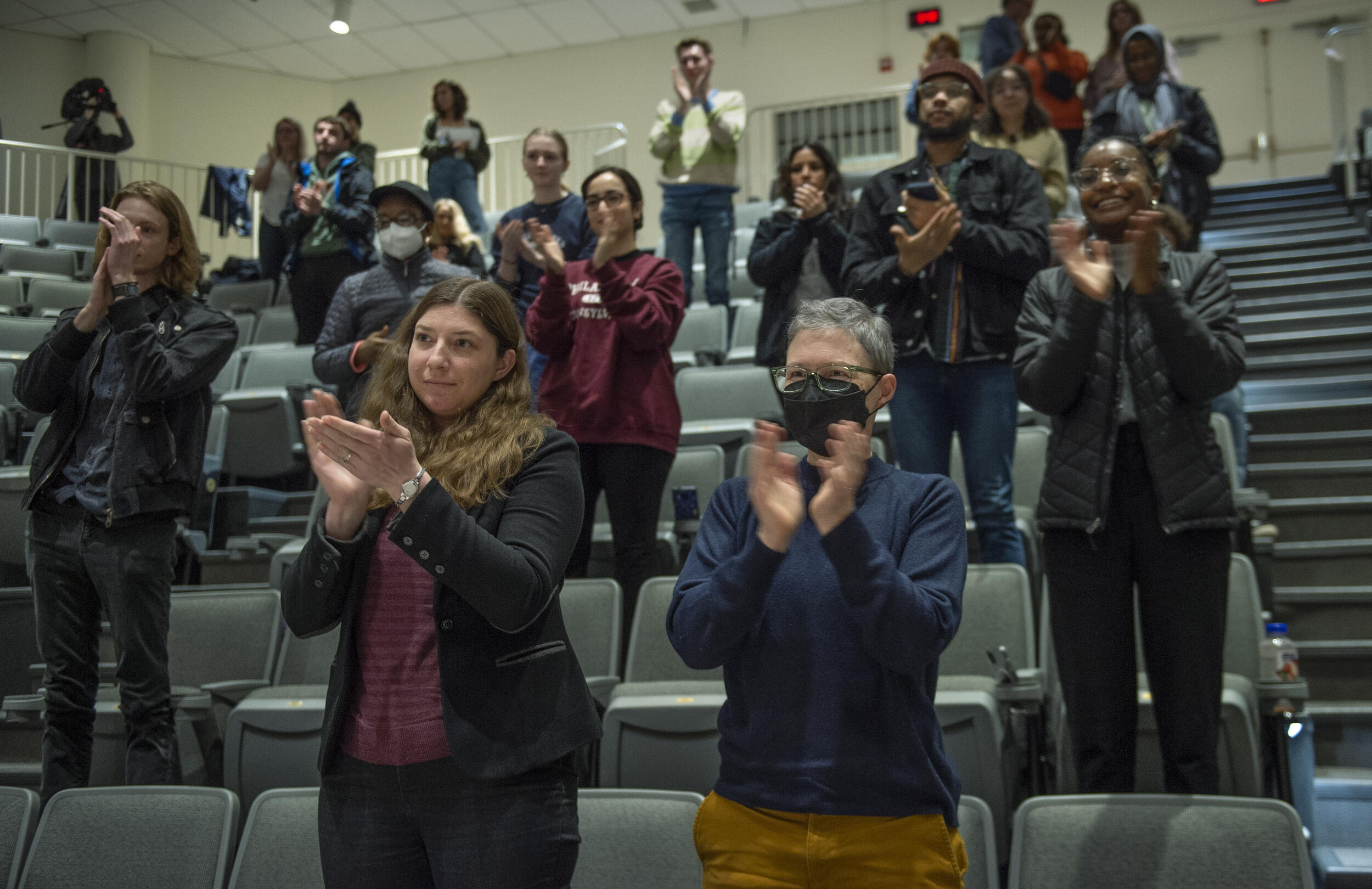 People standing up and clapping 