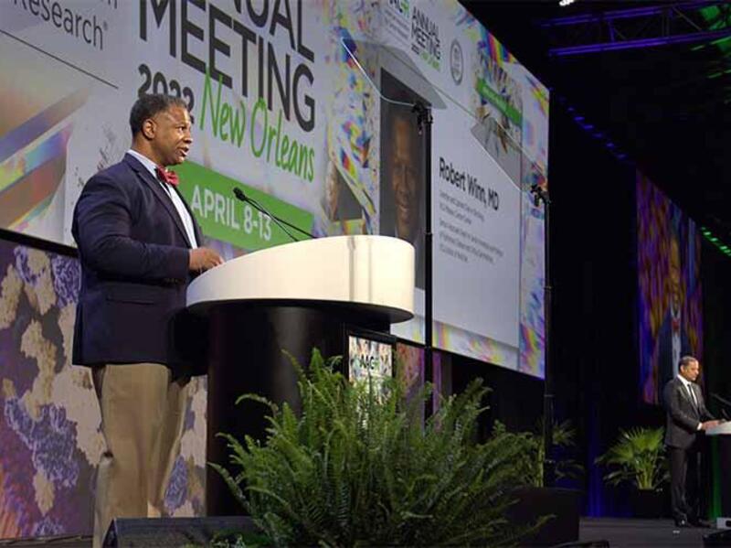 Robert Winn, standing at a podium.
