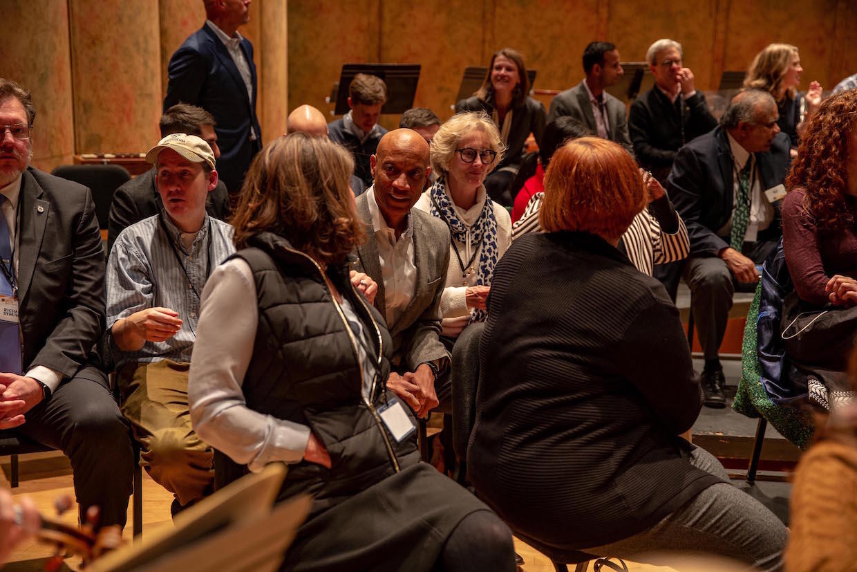 Ed Grier, middle, and School of Business faculty and staff sit in on a Richmond Symphony rehearsal of Beethoven’s fifth concerto.