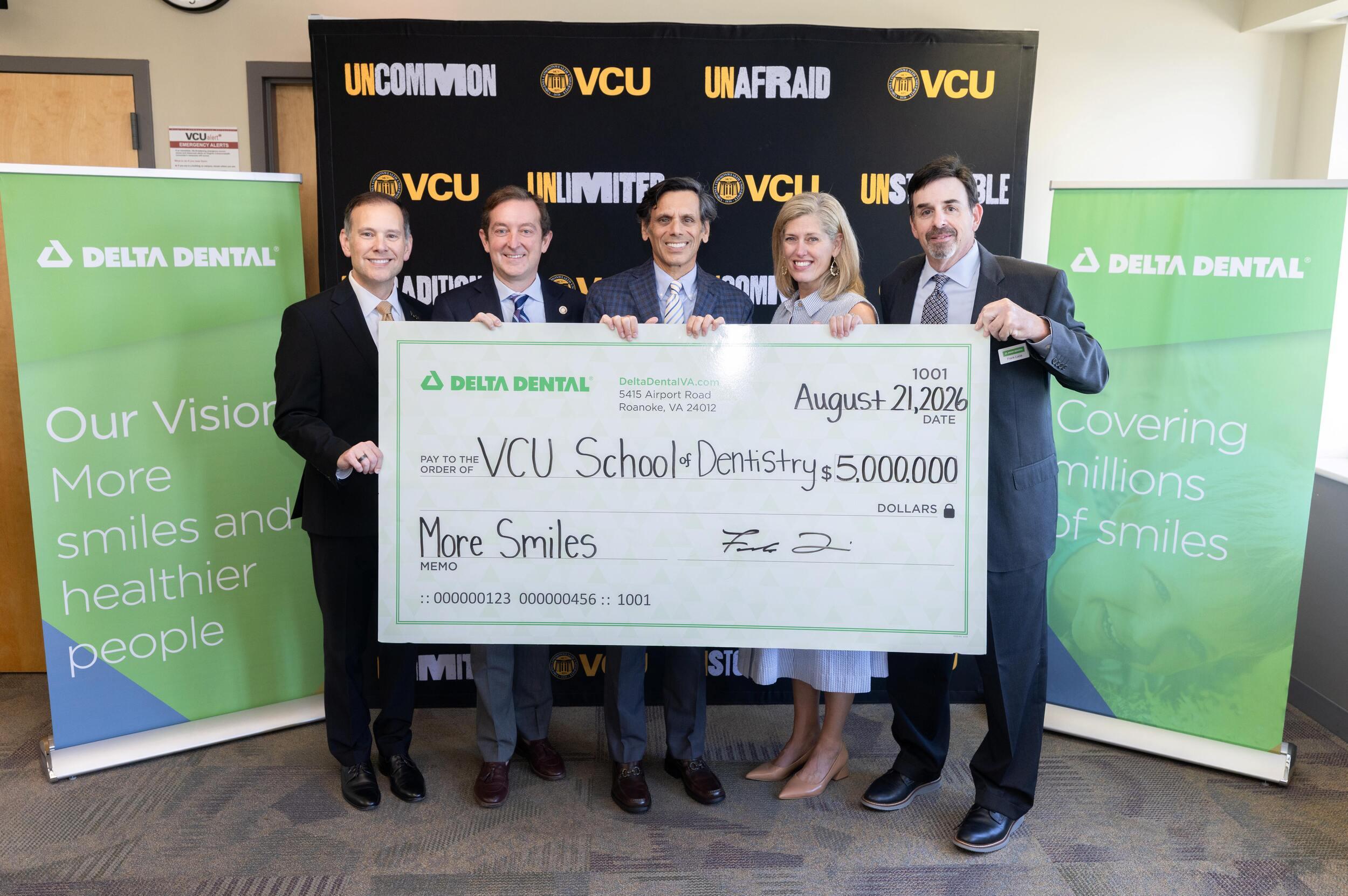 Four men and a woman stand behind a large check for $5 million made out to the VCU School of Dentistry.