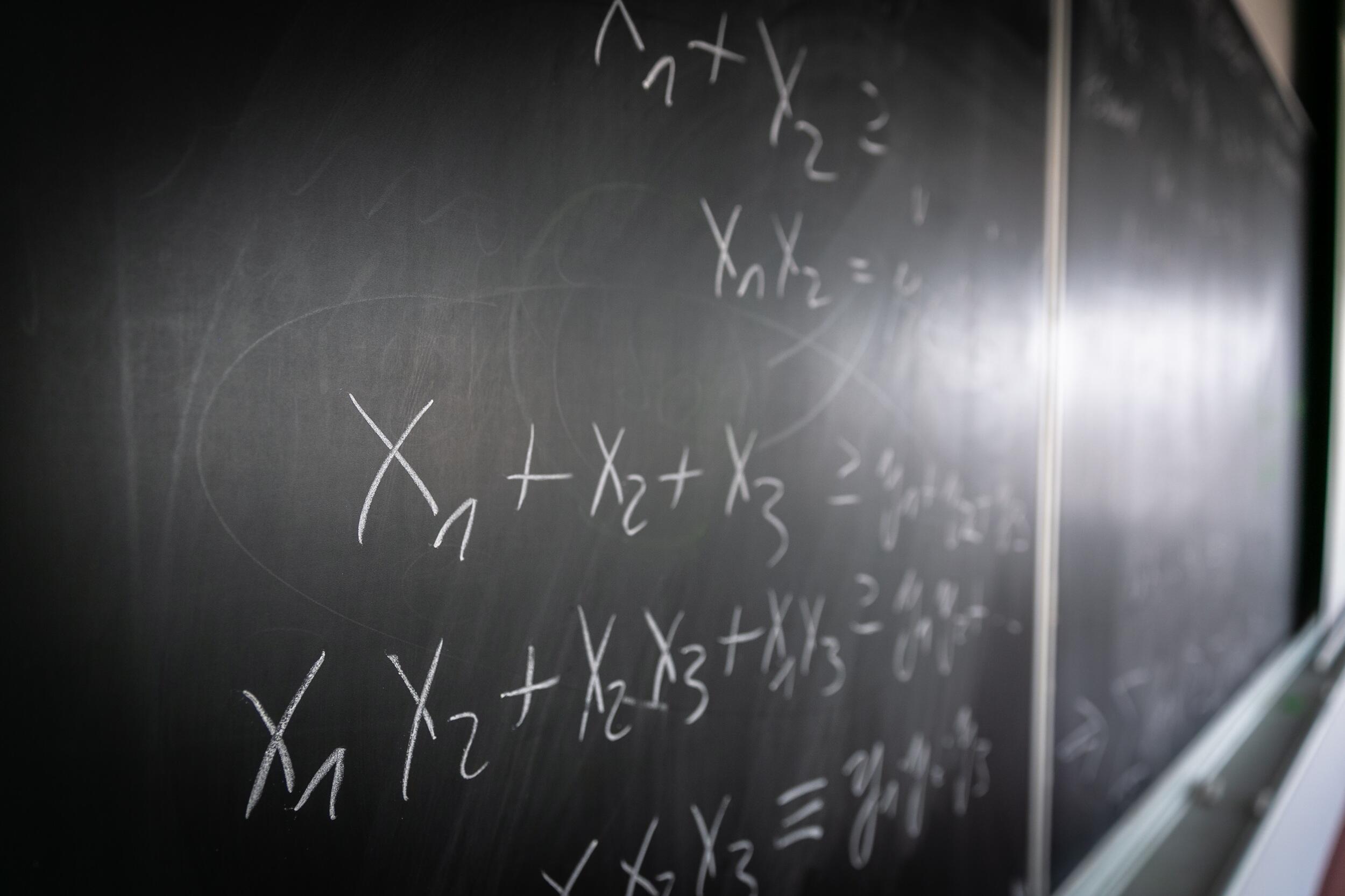 Mathematical equations written on a chalkboard.