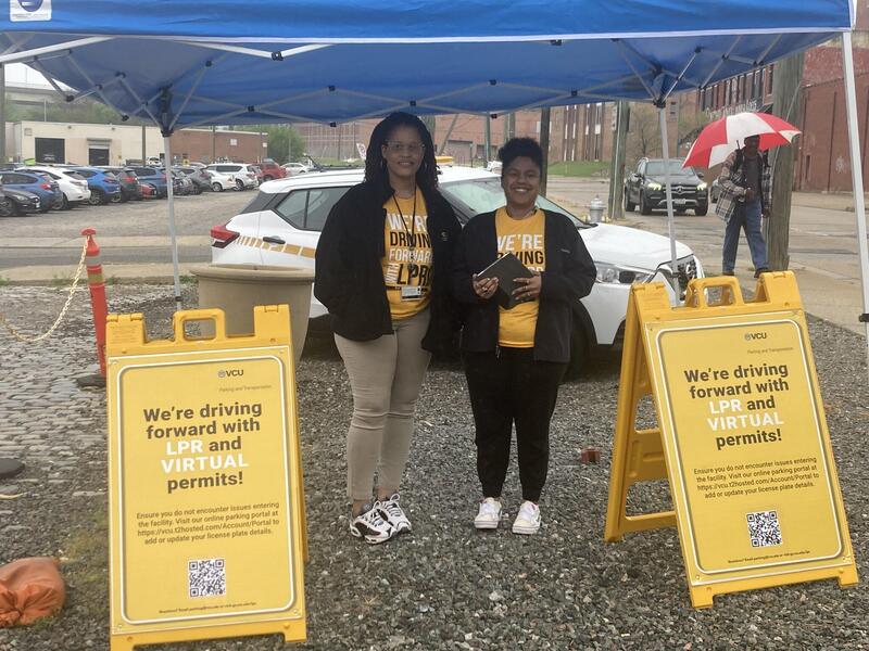 A photo of two women standing under a tent