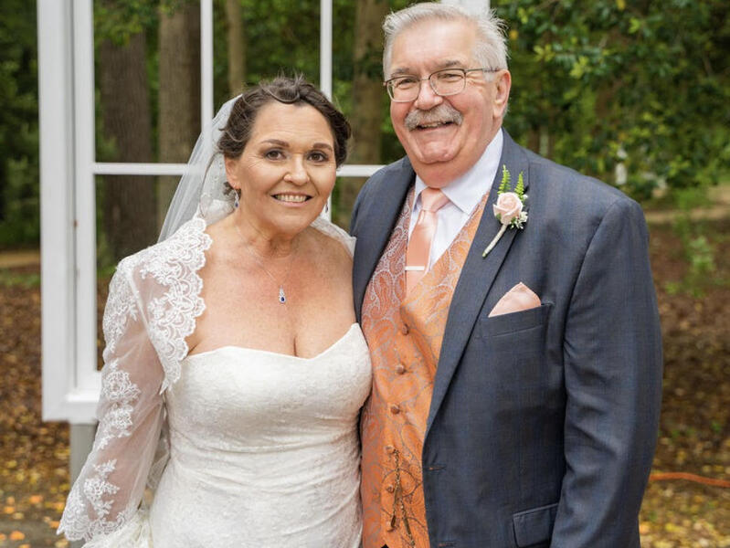 A bridge and groom smiling.