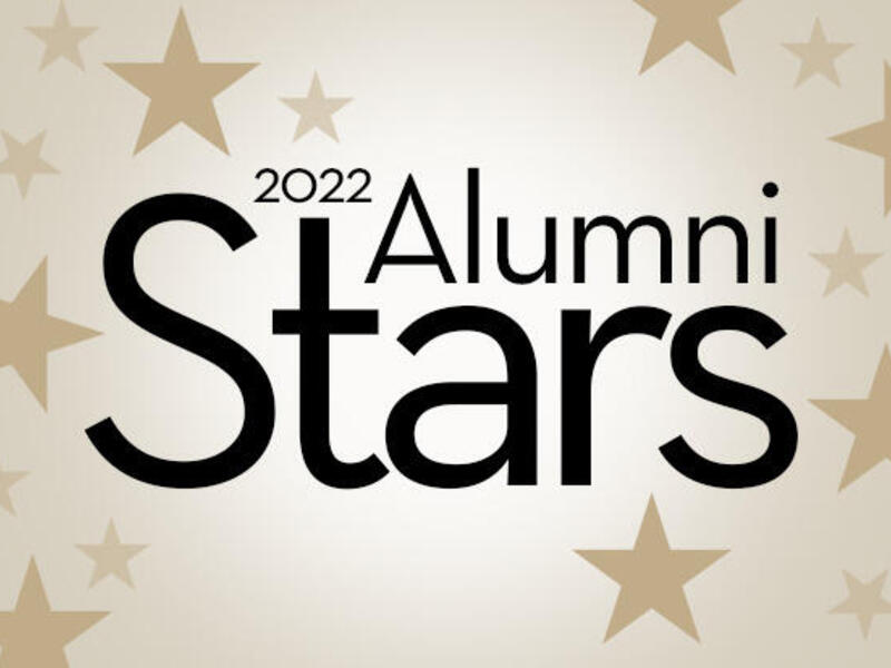 Black text that reads \"2022 Alumni Stars\" over a gold background with stars 