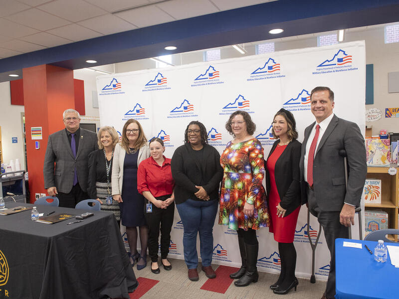 A group photo of eight people standing next to each other. 