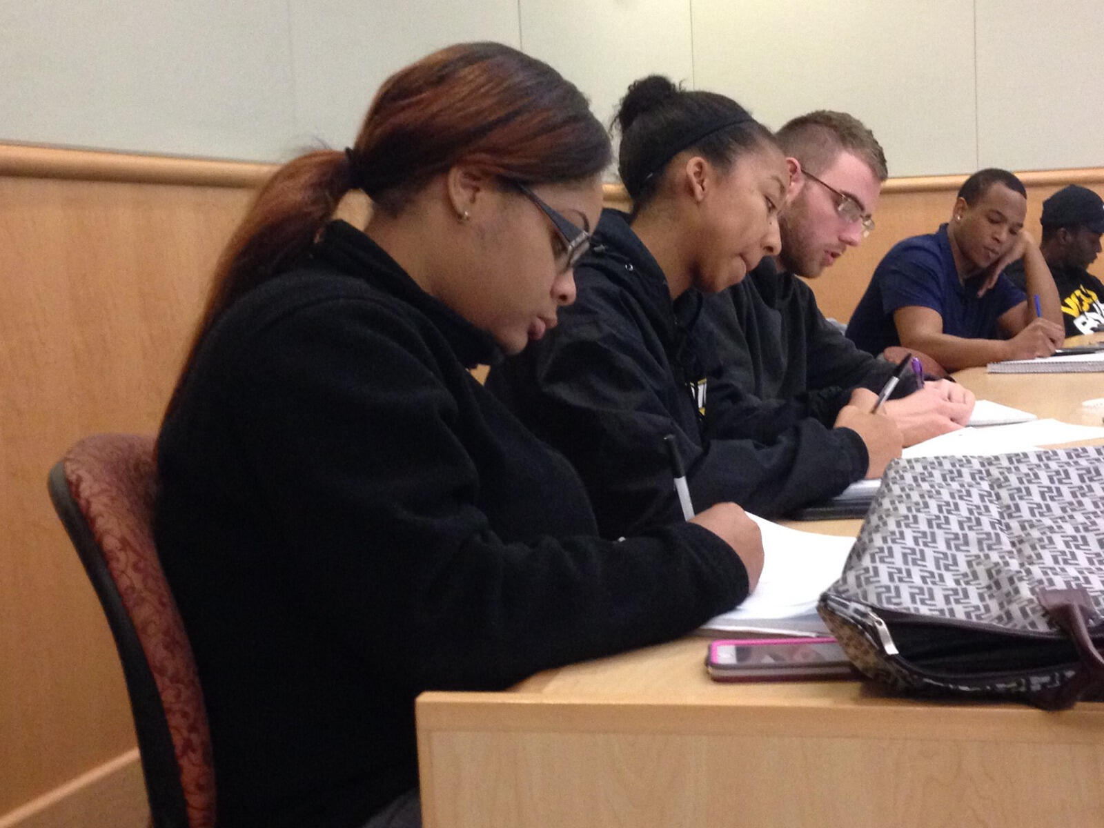 Creativity and Ideation students Jasmin Hurt, Danielle Williams and Alex Kaldmaa work on an in-class assignment — listing 100 things they could be doing other than sitting in class — that demonstrates divergent thinking.