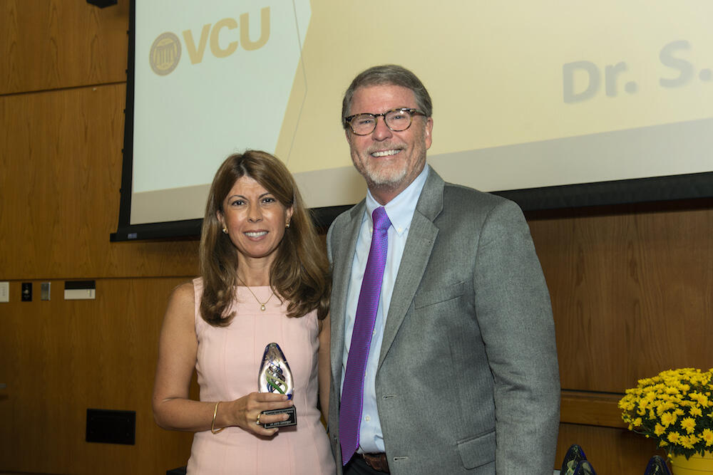 Sahingur with David Sarrett, dean of the School of Dentistry. (Photo courtesy of University Relations)