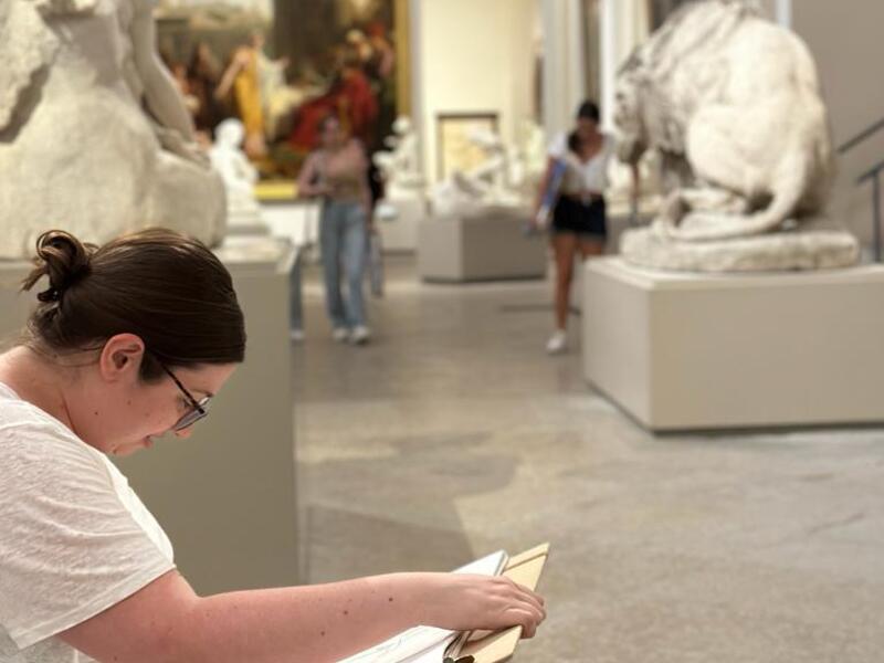 A photo of a woman drawing on a board 