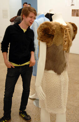 A visitor to the Anderson Gallery investigates a student work on display during the recent Juried Design Exhibition.
