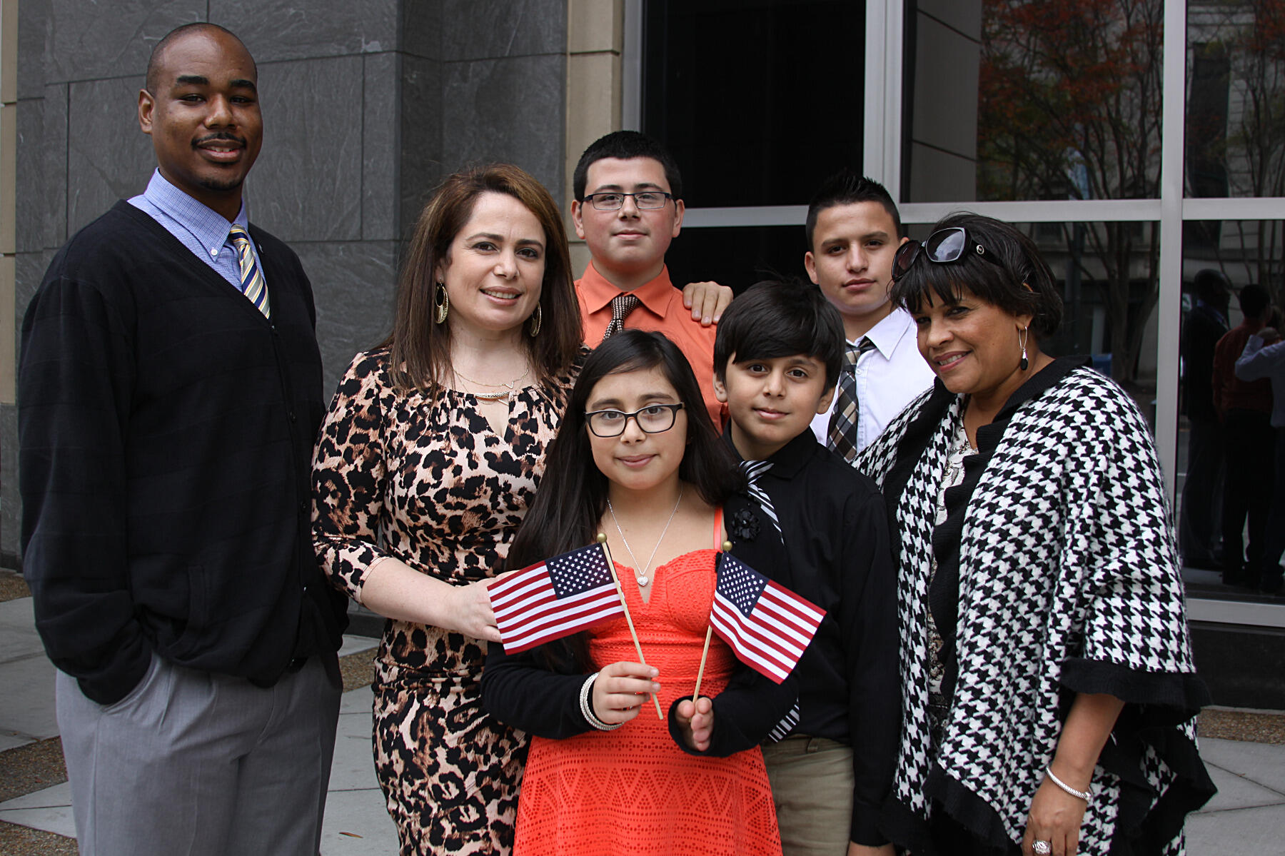 From left: Terrell Pollard, executive director of the Bridge CDC; new U.S. citizen Daisey Pinto; Pinto's daughter Ashley Arroyo, 10; son Jason Arroyo, 14; son Joshua Arroyo, 12; nephew Mizael Sagastume, 14; and Anita Nadal, an assistant professor of Spanish at VCU.
