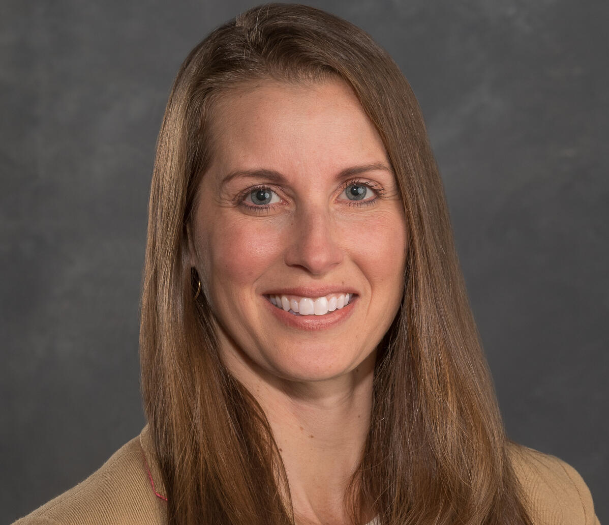 A photo of a woman from the shoulders up. 