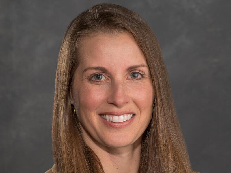 A photo of a woman from the shoulders up. 