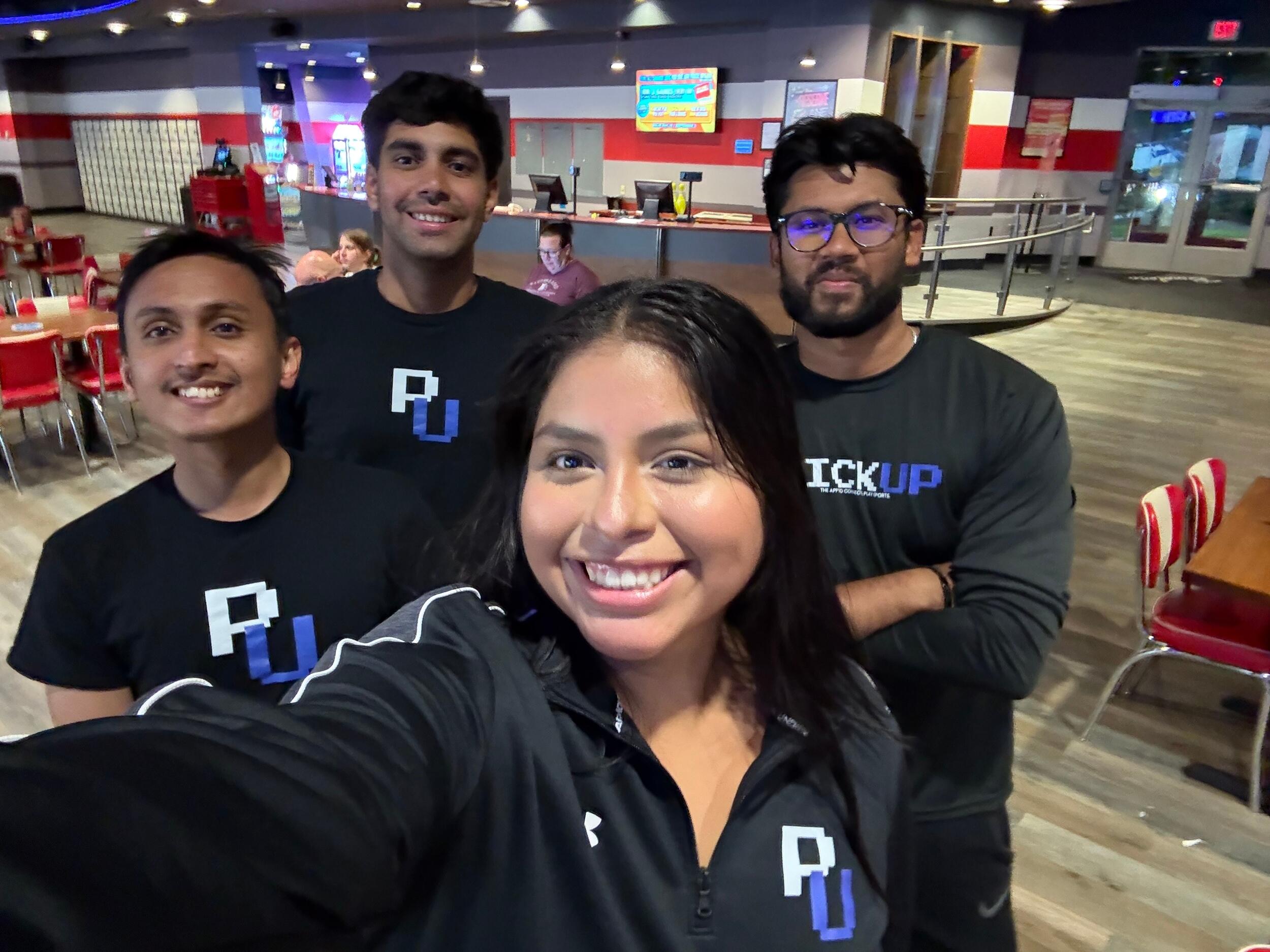 A group photo of four people. 