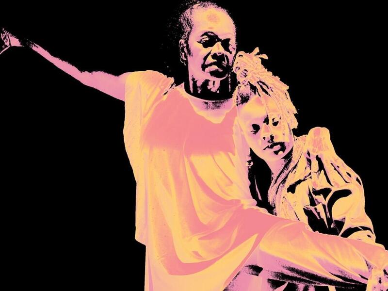 A man and women dancing next to a portrait of a woman smiling 