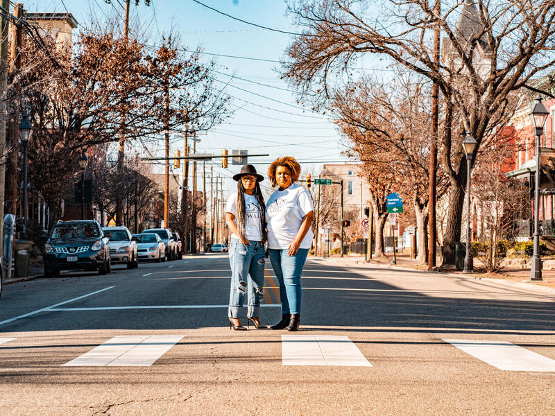 Enjoli and Sesha Joi Moon standing in the middle of the street in Jackson Ward