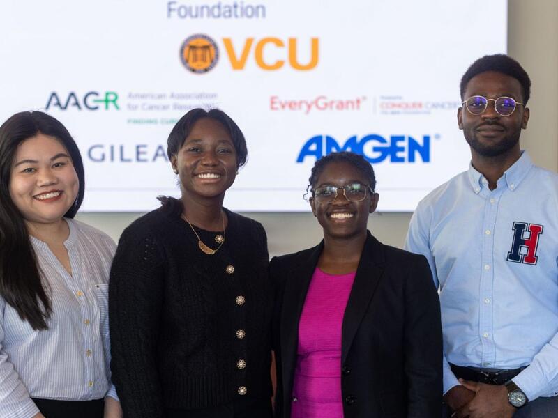 A photo of four people standing next to each other. 