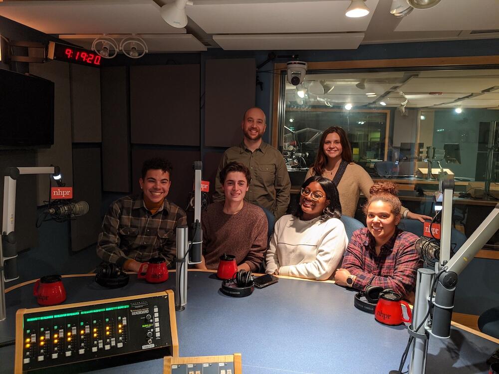 Students smile in a radio station. 