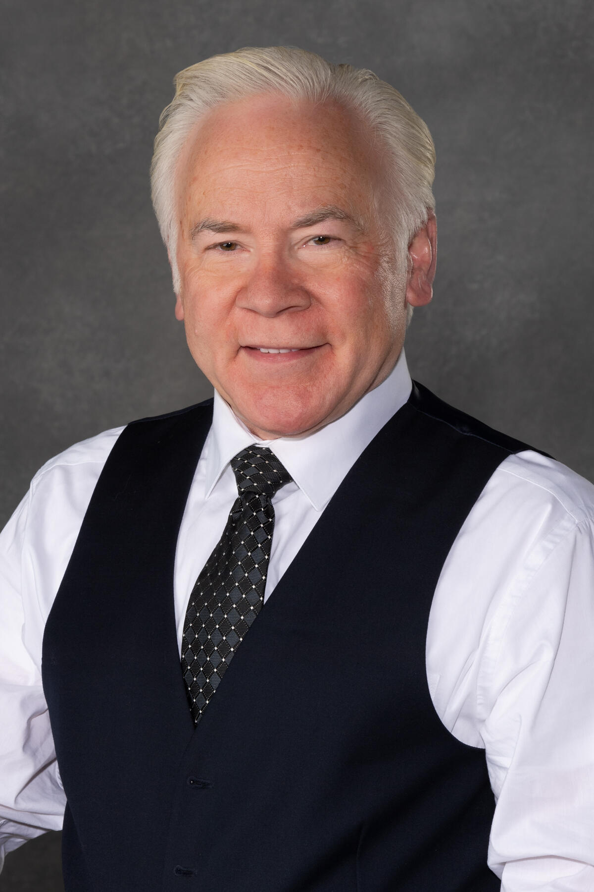 A portrait of a man from the chest up. 