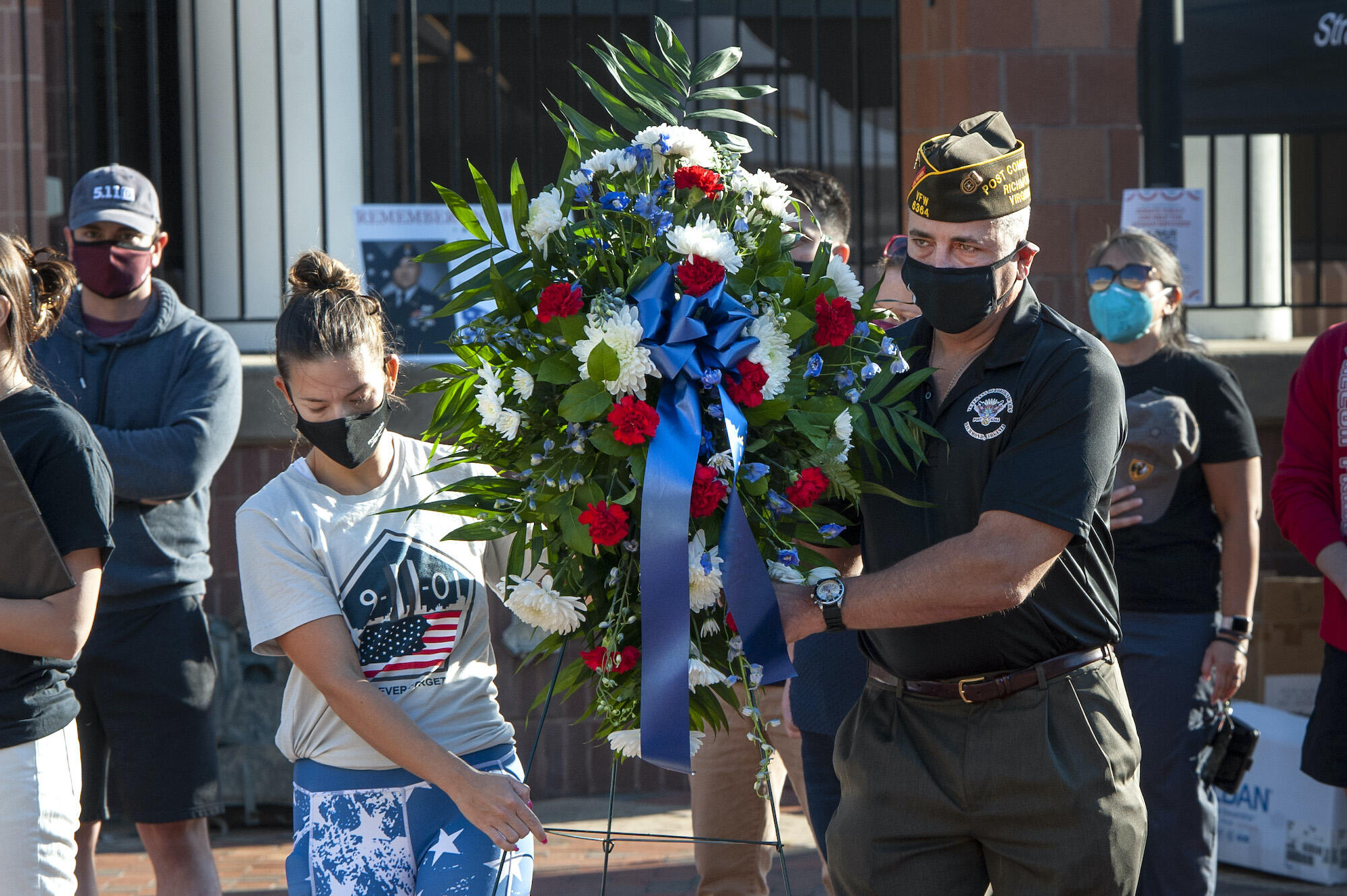 Shae Hockaday, left, and Mike Purcell carry a wreath at VCU's 9/11 anniversary ceremony. 