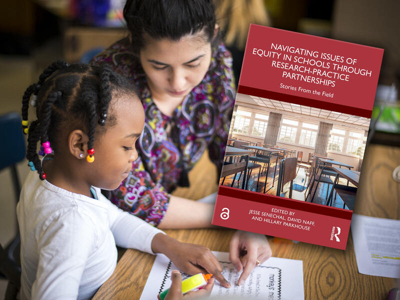 A teacher works with a student at a desk. Both point at a piece of paper. A book cover is inserted into the image.