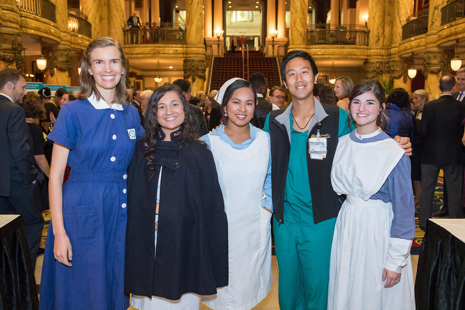 Students stand wearing a variety of nurse outfits