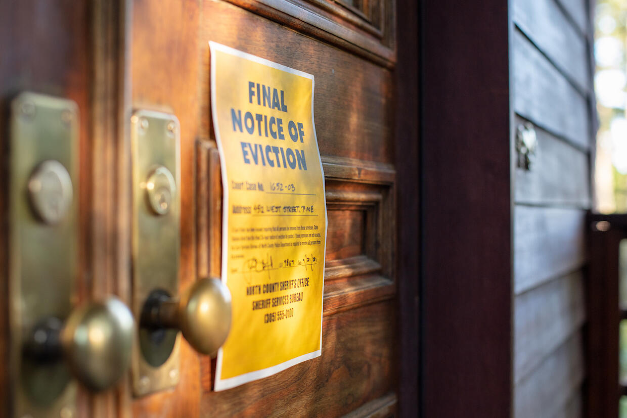 an eviction notice nailed to a door