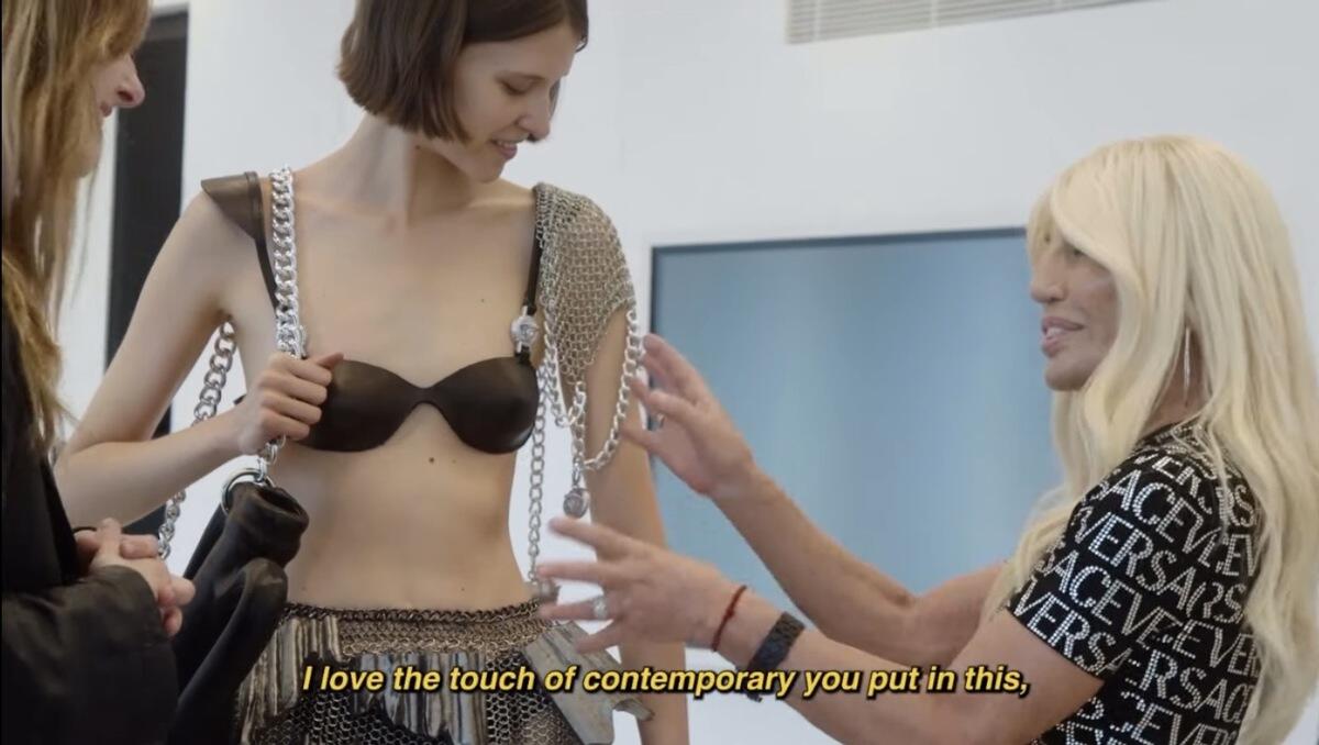 Two women standing next to a model