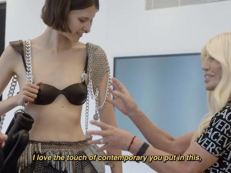 Two women standing next to a model