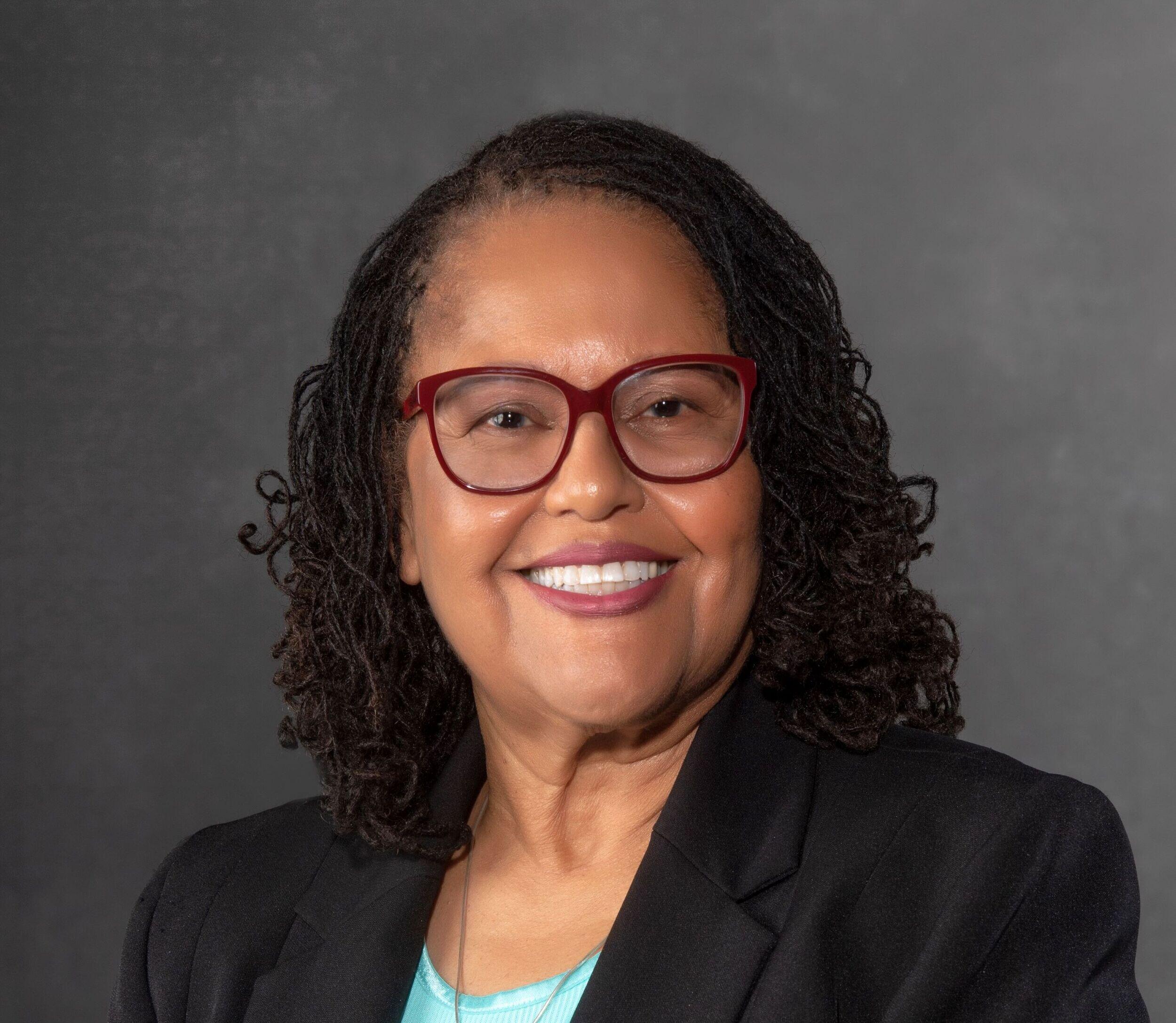 Portrait of Faye Belgrave, who is smiling.