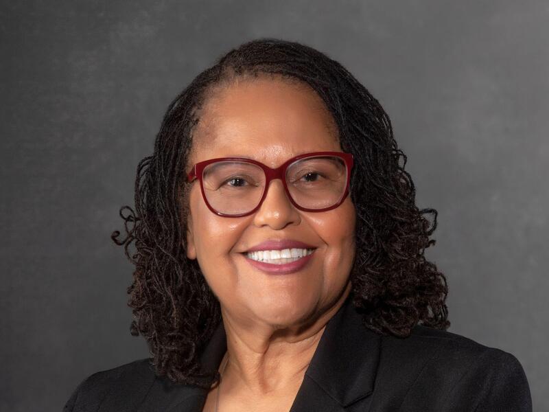 Portrait of Faye Belgrave, who is smiling.