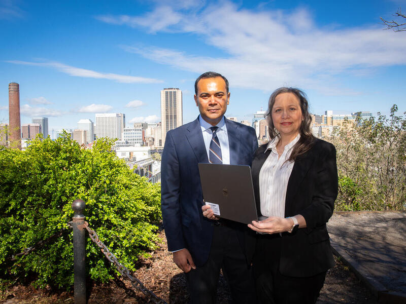 A photo of a man and woman standing in front of the Richmond skyline