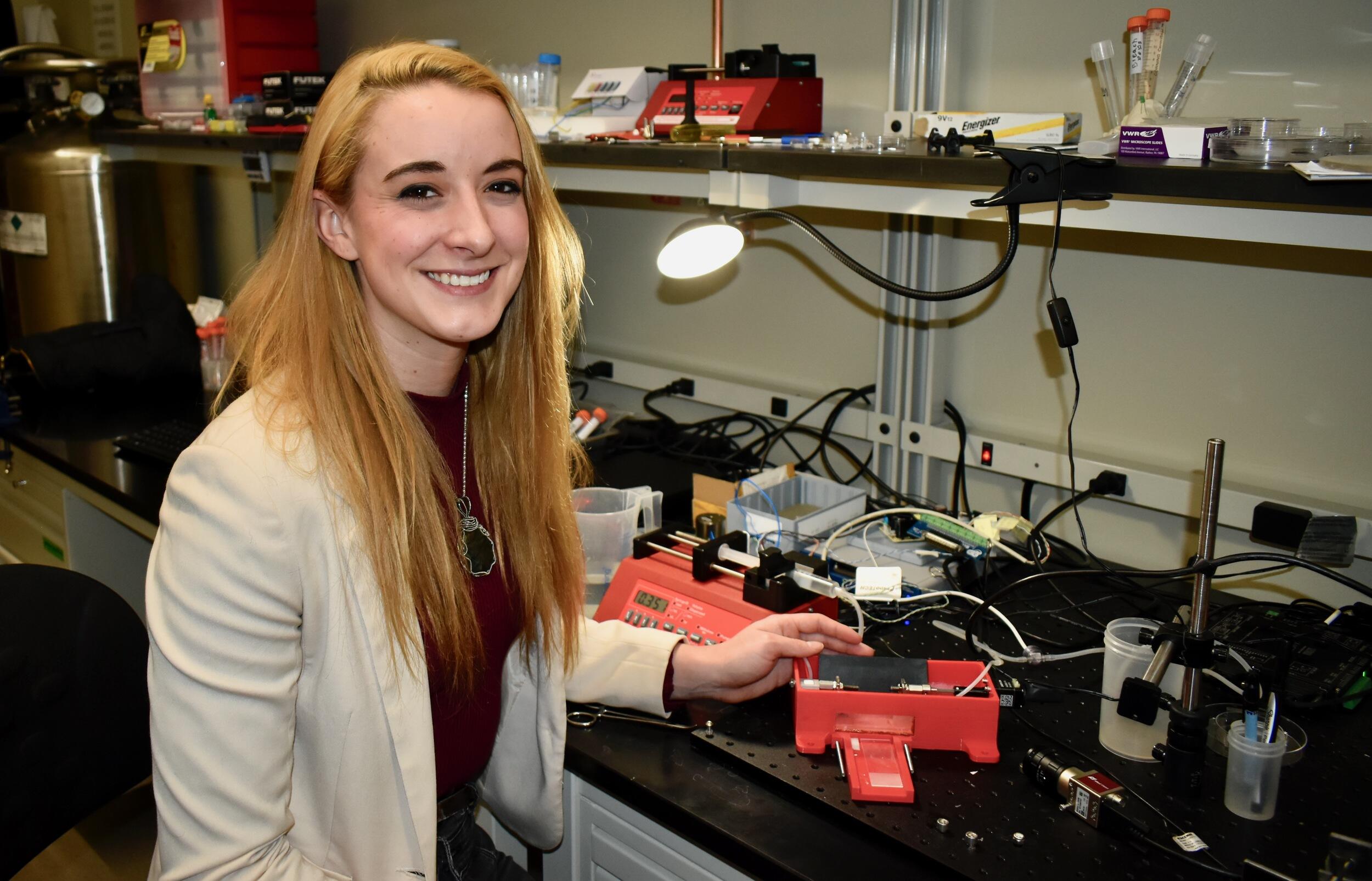 Sarah Saunders seated in a laboratory.