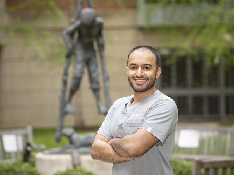 Abdullah Alawadhi smiling with his arms crossed. 