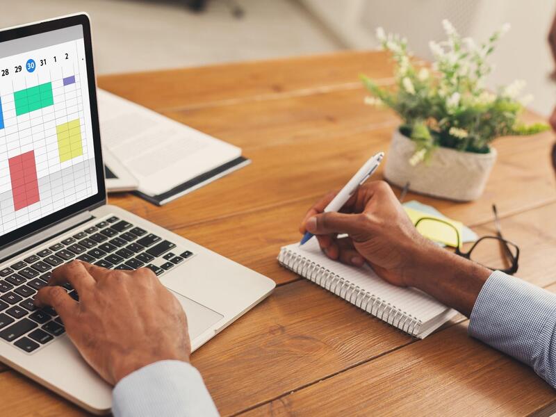 unidentified man updating his work digital calendar