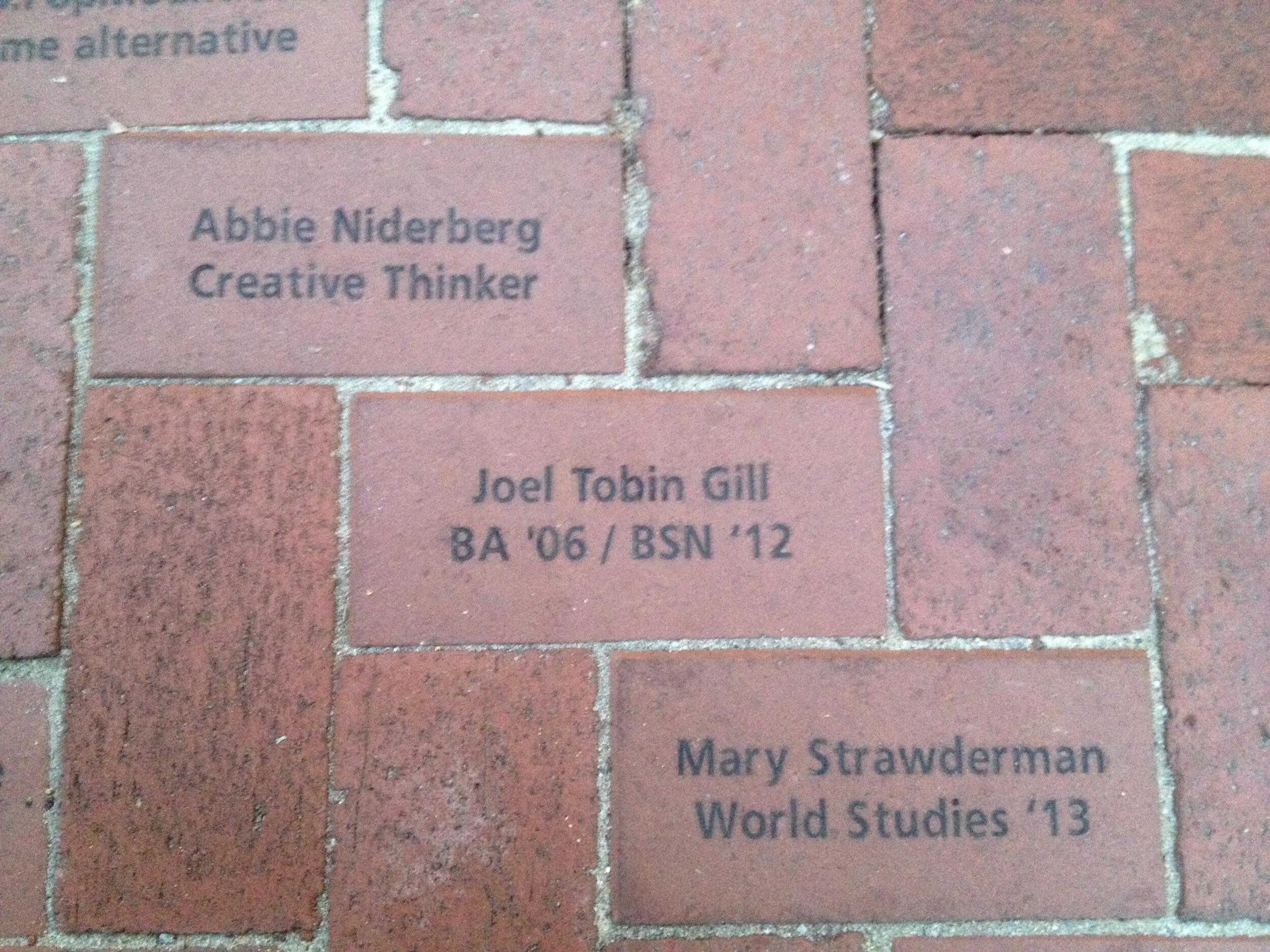 A photo of a brick that says \"Joel Tobin Gill\" \"BA '06/BSN '12\"