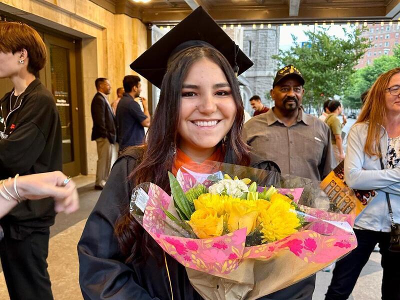 A photo of a woman wearing a graduation cap and gown 