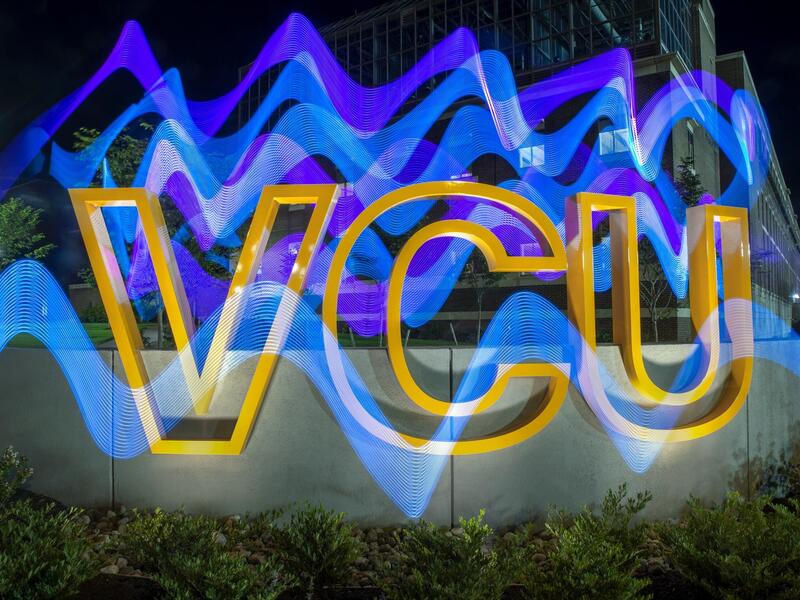 Yellow letters that spell \"V-C-U\" with blue wavy lines over them 