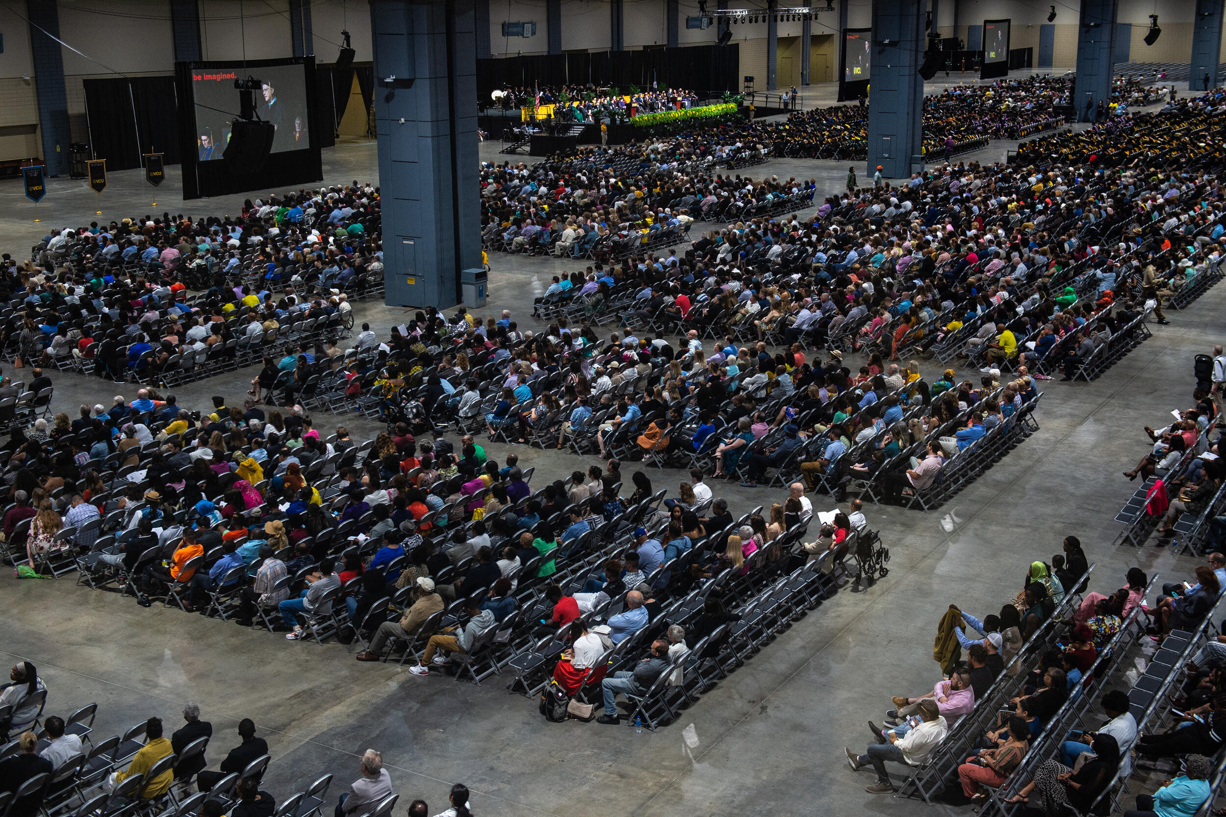 Rows of people sitting in chairs.