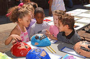 Children from VCU's Child Development Center gather around their artwork during the silent auction. Presented by VCU's Just Say Hello Campaign, the auction featured the childrens' artwork that will benefit the center in the creation of an outdoor play area for children.