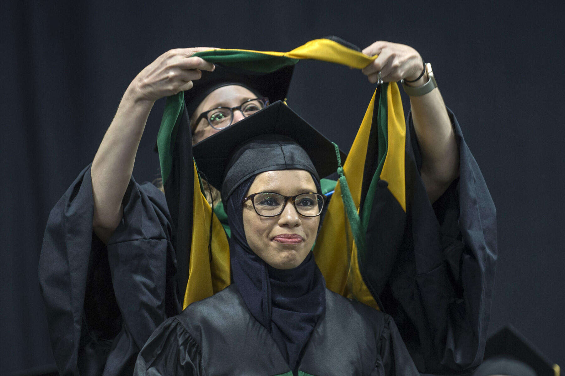 Graduating medical student Kawthar Yusuf, M.D., receives her doctoral hood, signifying her success in completing the medical school graduate program. (Photo by Kevin Morley, University Relations)