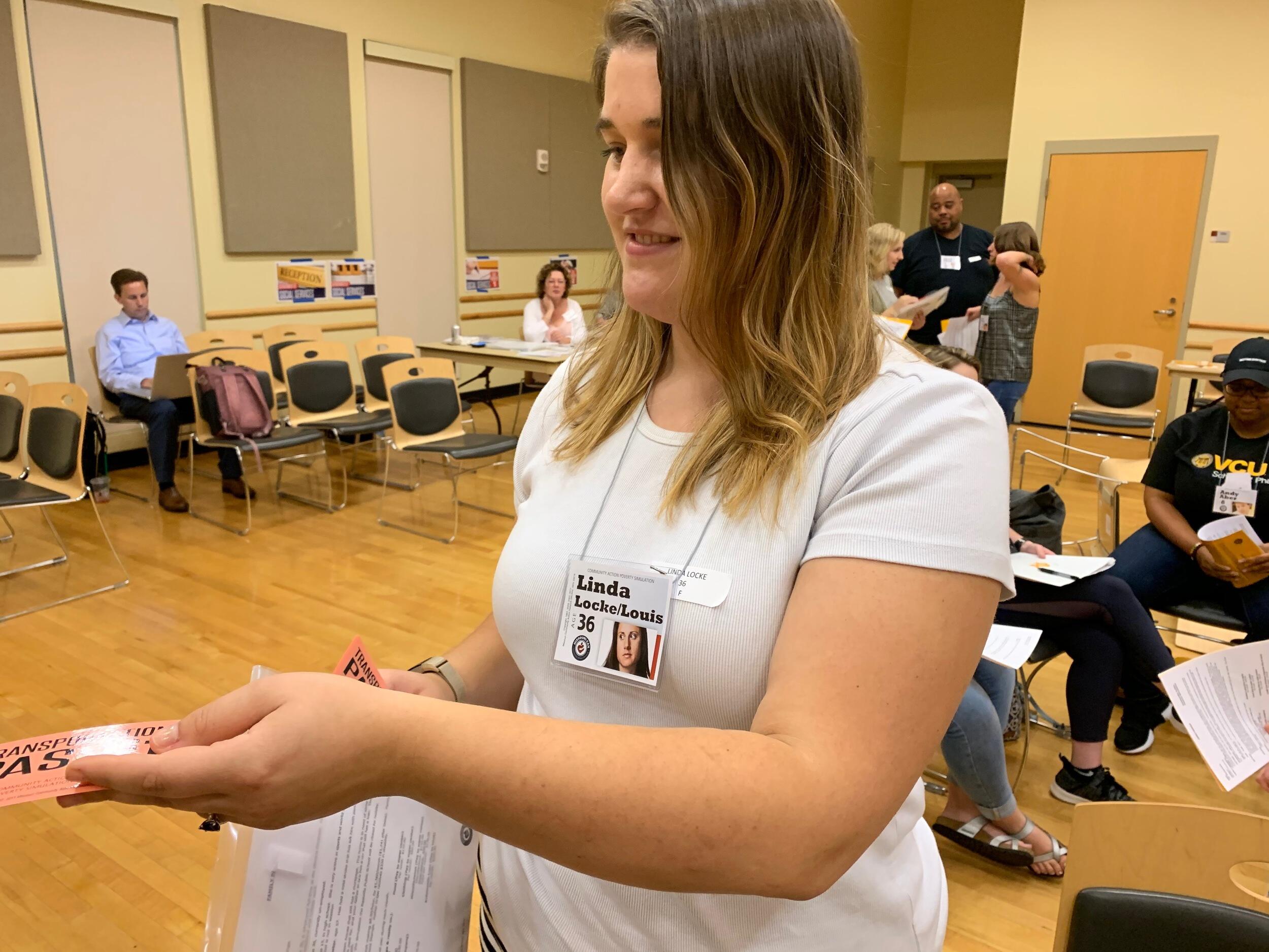 A student holding a transportation ticket.