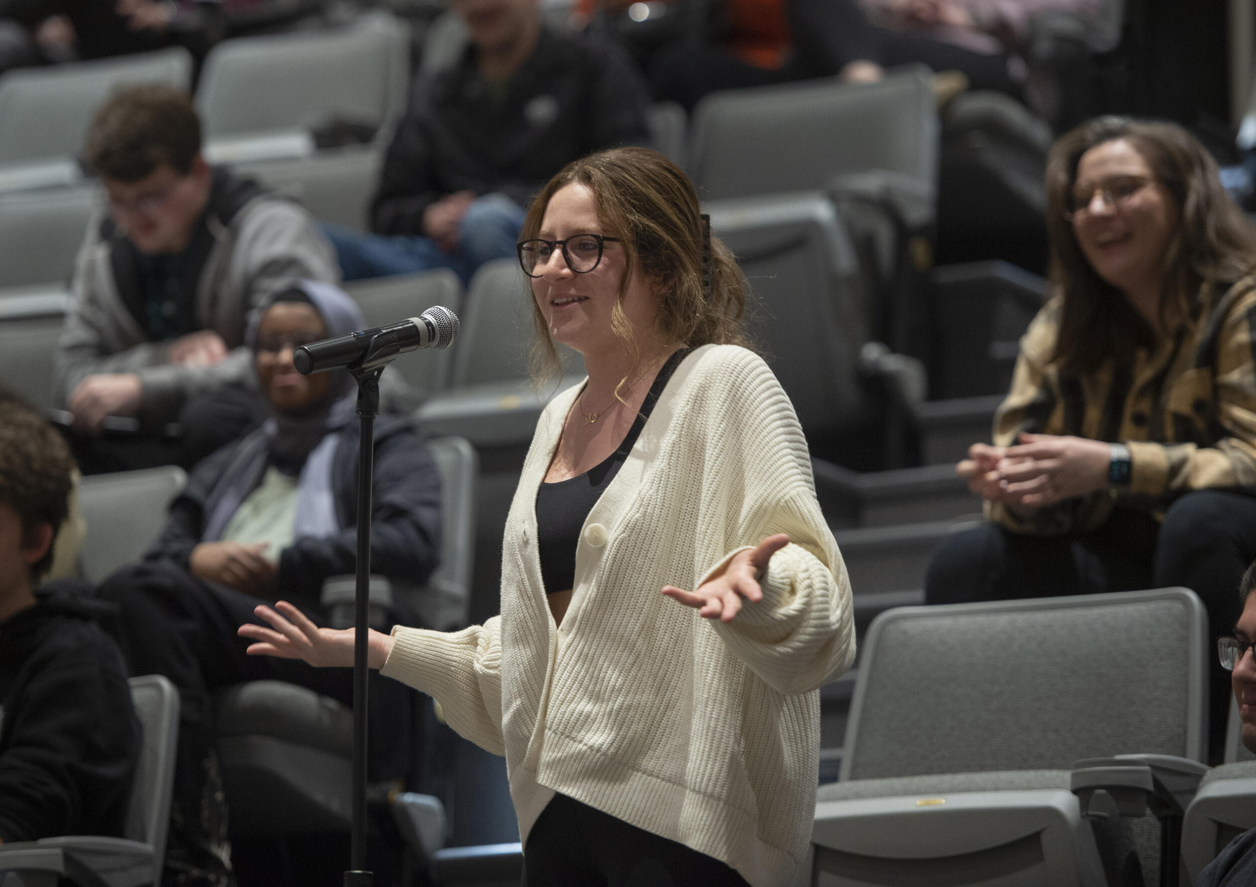 A woman standing in front of a microphone 