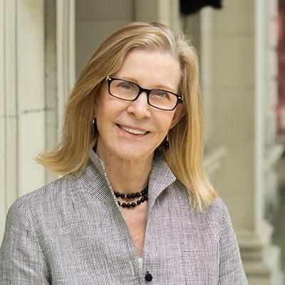Portrait image of smiling woman in glasses.
