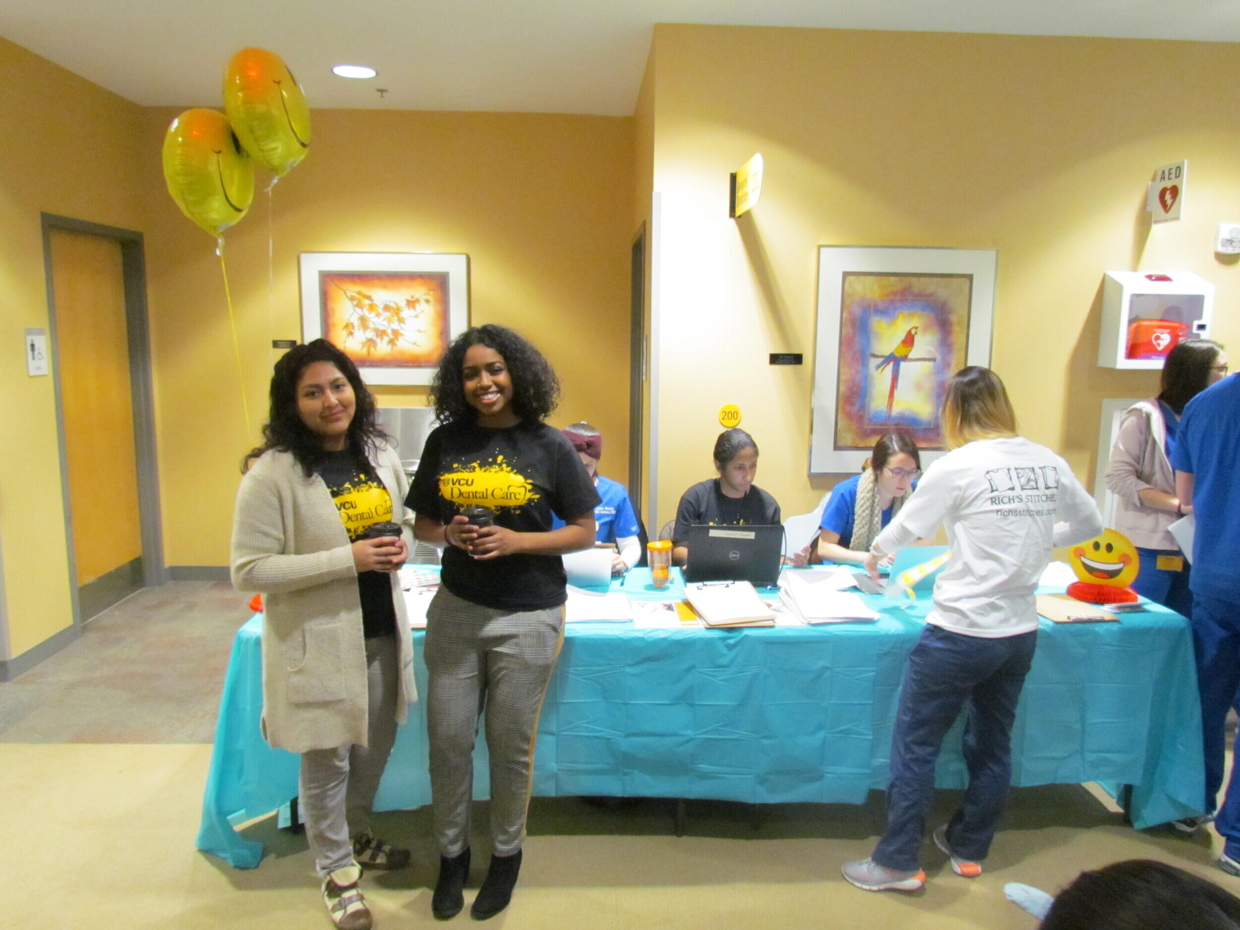 A sign-in desk at a Give Kids a Smile dentistry event.