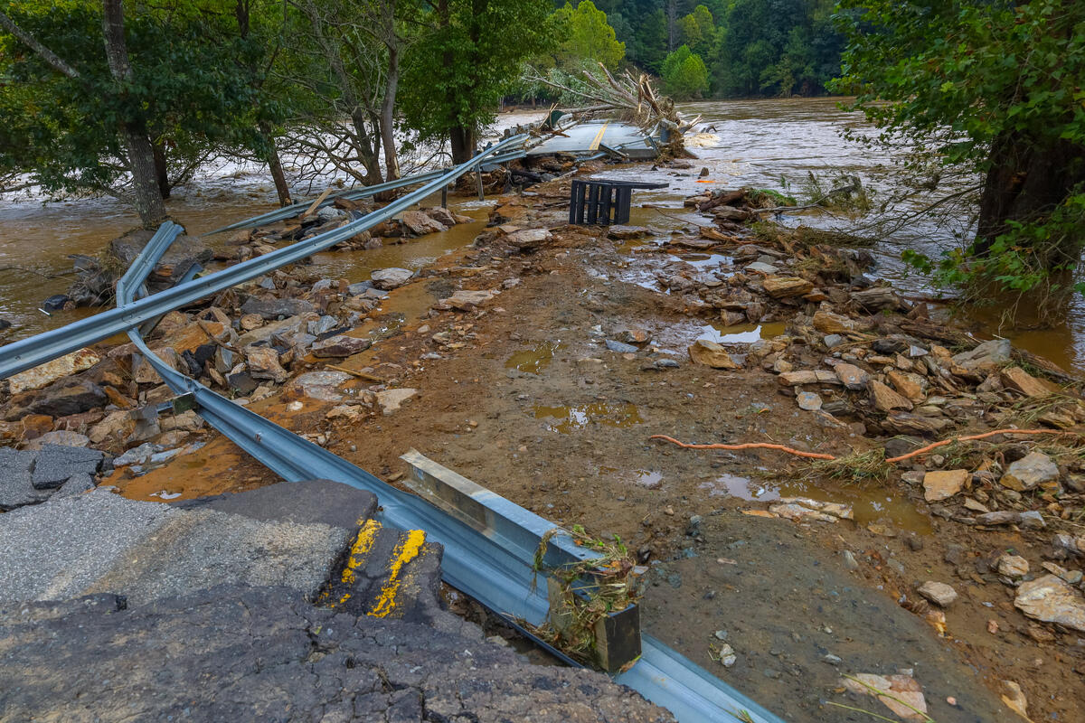 A photo of a road that has been washed out by a storm. 