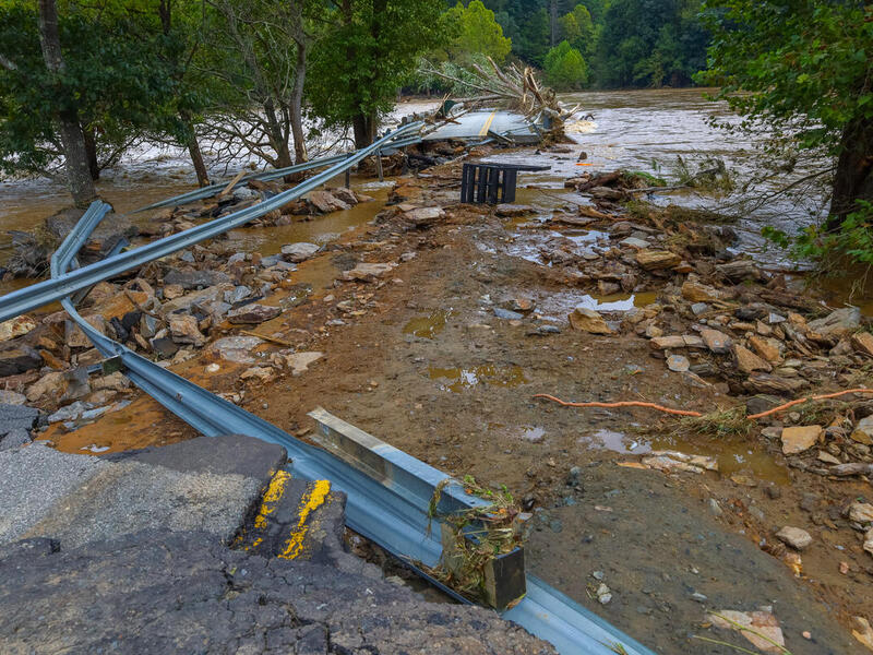 A photo of a road that has been washed out by a storm. 