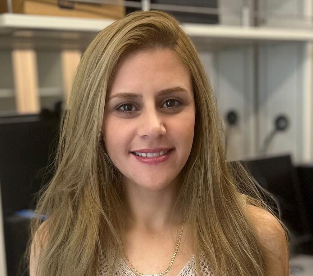 A photo of a woman from the shoulders up. 